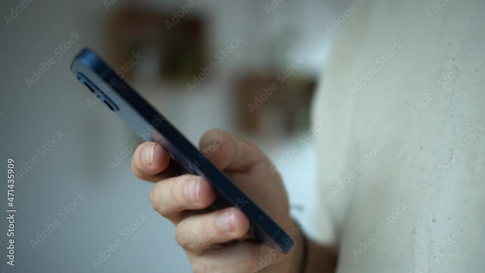A man holding his smartphone and texting standing in an isolated white background. Chatting concept A man holding his smartphone and texting standing in an isolated white background. Chatting concept