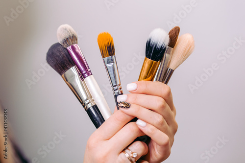 make up brushes in hands of a make up artist