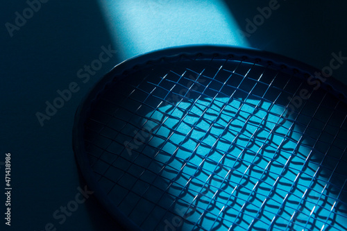 White professional tennis racket with natural lighting on blue background. Horizontal sport theme poster, greeting cards, headers, website and app