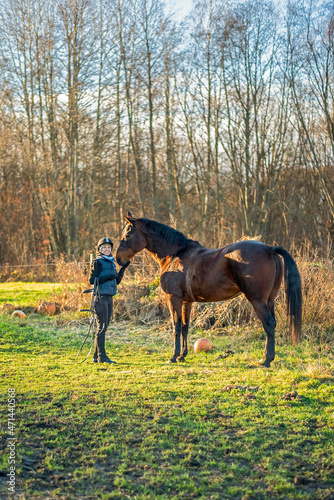 happy woman in farmland with horse