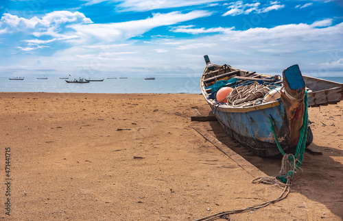 Fishing boat missions on the beach waiting for the next fishing trip. This boat is located on the tropical shore of Keta Ghana West Africa 2021