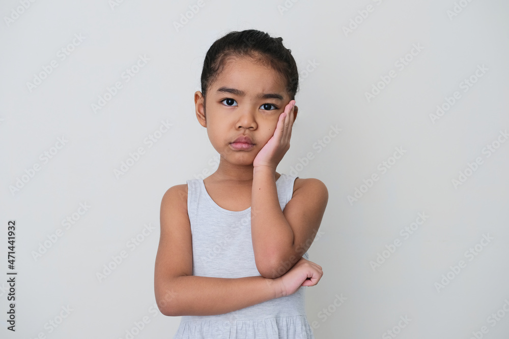 Asian little girl looking forward with boring expression Asian little girl looking forward with boring expression