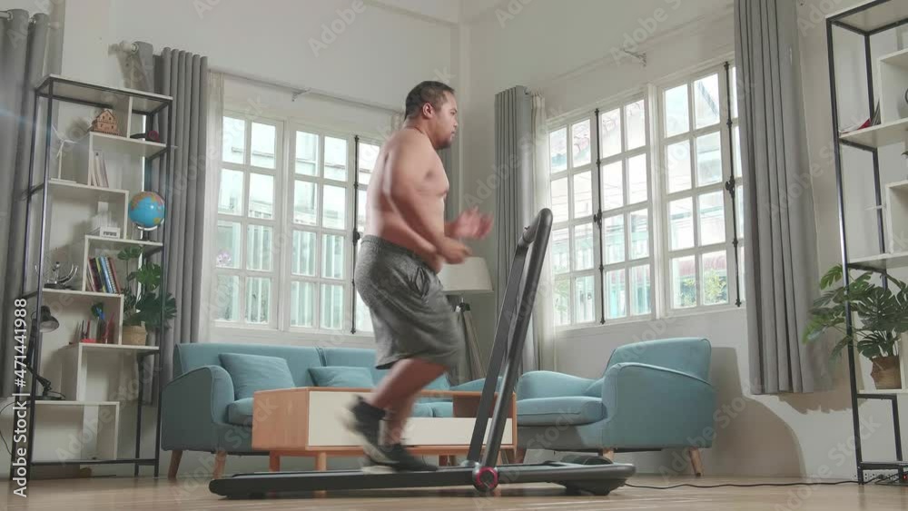 Asian Fat Man Wearing No T-Shirt And Running On A Treadmill At Home
Asian Fat Man Wearing No T-Shirt And Running On A Treadmill At Home