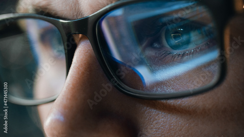 Close-up Portrait of Software Engineer Working on Computer, Line of Code Reflecting in Glasses. Developer Working on Innovative e-Commerce Application using Machine Learning, AI Algorithm, Big Data photo