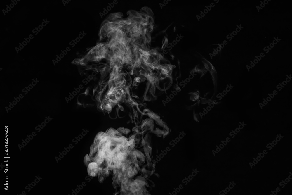 Fragment of white hot curly steam smoke isolated on a black background, close-up. Abstract background, design element Fragment of white hot curly steam smoke isolated on a black background, close-up. Abstract background, design element