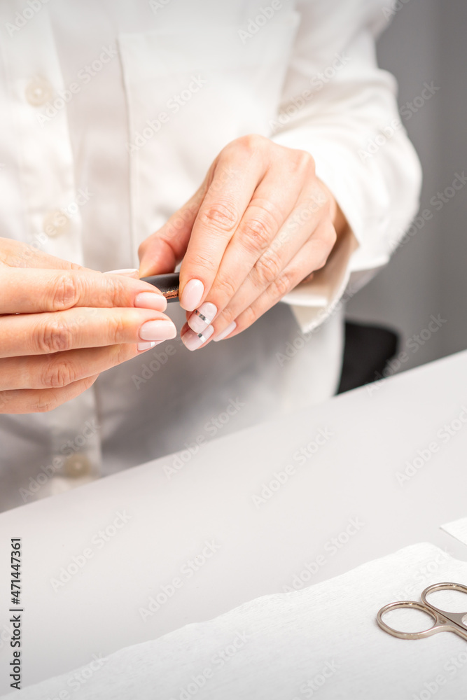 Professional manicurist preparing tools for doing clients nails