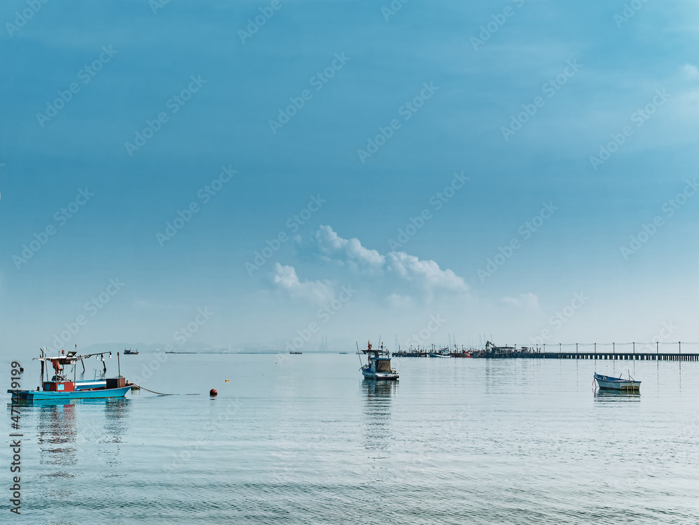 Fishing Boats Floating on the Sea at the Pier Against Blue Cloudy Sky