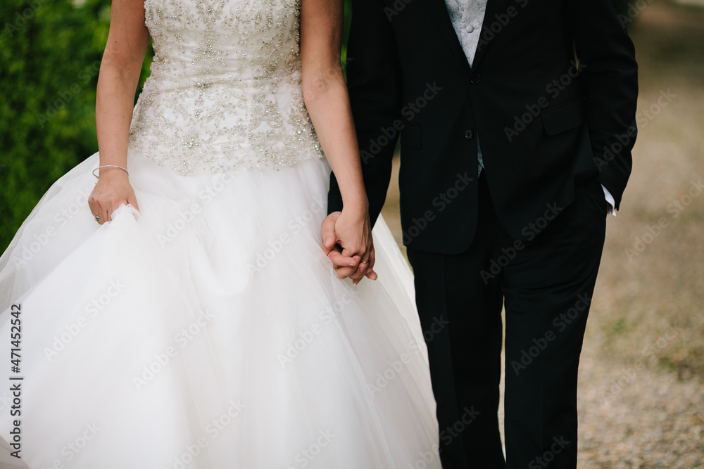Bride and groom holding standing together close on wedding day outdoors .Togetherness concept Bride and groom holding standing together close on wedding day outdoors .Togetherness concept