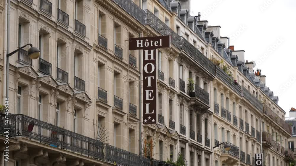 Paris hotel vertical signboard on a building facade in beautiful city center Paris hotel vertical signboard on a building facade in beautiful city center