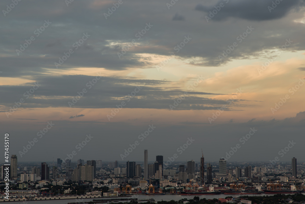 Bangkok, Thailand - Sep 12, 2021 : Gorgeous panorama scenic of the sunrise or sunset with cloud on the orange and blue sky over large metropolitan city in Bangkok. Copy space, No focus, specifically.
