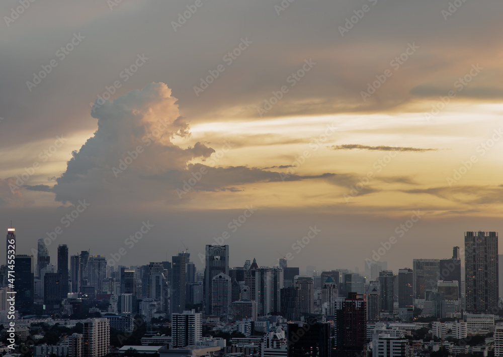 Fototapeta premium Bangkok, Thailand - Sep 17, 2021 : Aerial view of Beautiful sunset over large metropol city in Asia. With tall building and skyscraper in background. Monotone, No focus, specifically.