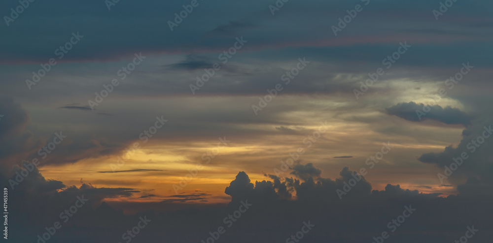 Panoramic of lighting shines through the clouds in the sunset sky with dramatic light. The shape of the clouds evokes imagination and creativity. They can be used as wallpapers that look amazing. Beau