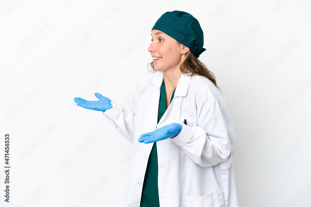 Surgeon caucasian woman in green uniform isolated on white background with surprise facial expression Surgeon caucasian woman in green uniform isolated on white background with surprise facial expression