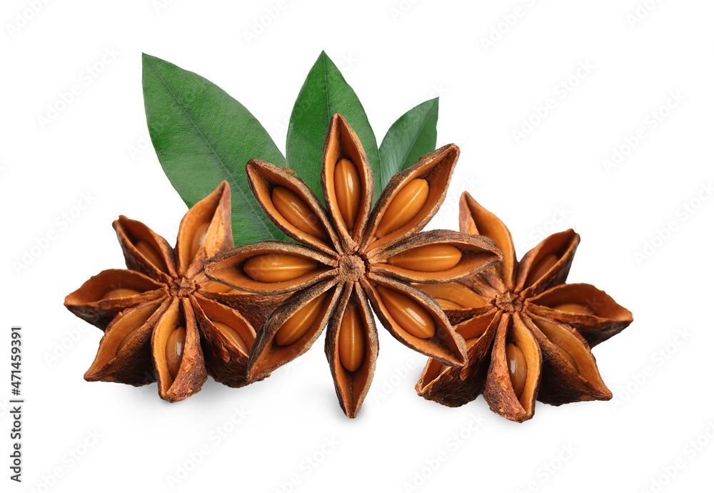 Aromatic dry anise stars and green leaves on white background Aromatic dry anise stars and green leaves on white background