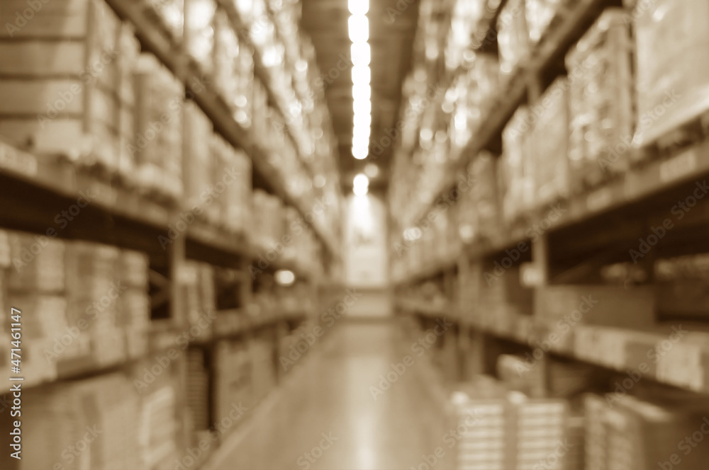 Abstract blurred warehouse shelves with boxes in sepia tone