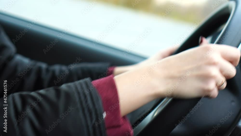 Woman driver hand on car steering wheels. Woman drive auto Woman driver hand on car steering wheels. Woman drive auto