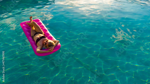 Young woman in the pool in greece