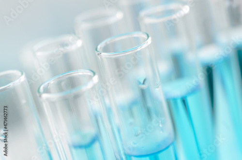 Scientific laboratory research and experiments. Laboratory test tubes with blue liquid close-up, selective focus.