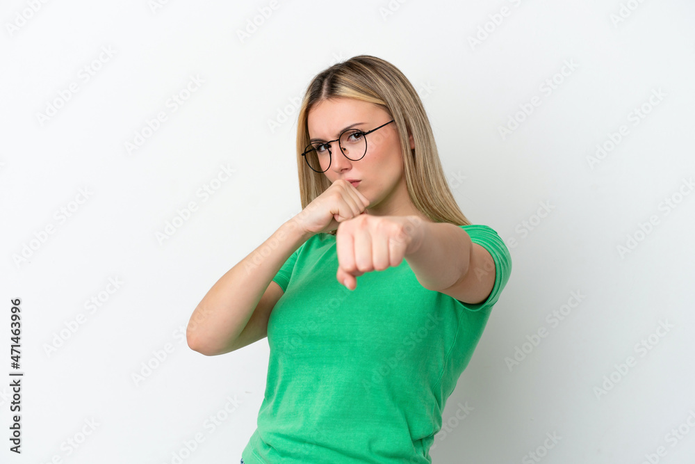Fototapeta premium Young caucasian woman isolated on white background with fighting gesture