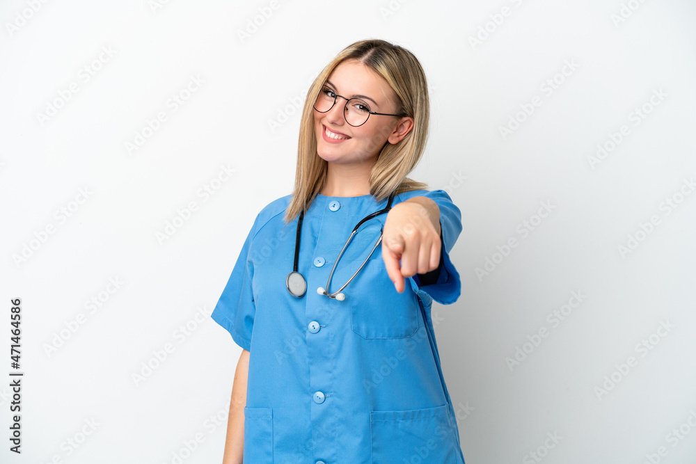 Young surgeon doctor woman isolated on white background pointing front with happy expression Young surgeon doctor woman isolated on white background pointing front with happy expression