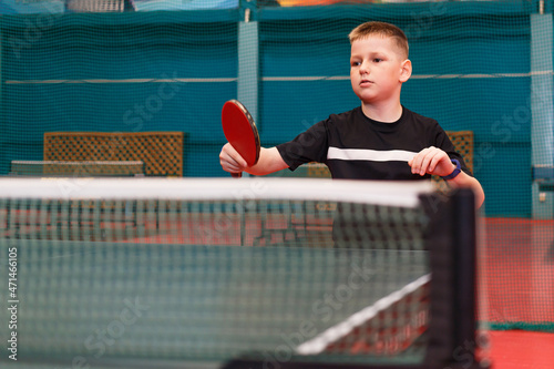 boy playing table tennis, photo through the net