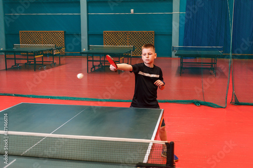 the child plays table tennis professionally. children's training in table tennis. Shock testing