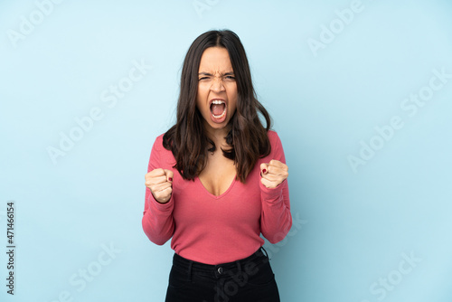 Young mixed race woman isolated on blue background frustrated by a bad situation © luismolinero