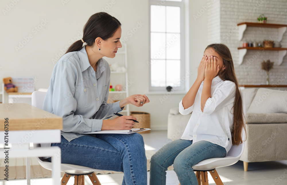Counseling psychologist trying to help sad stressed kid to