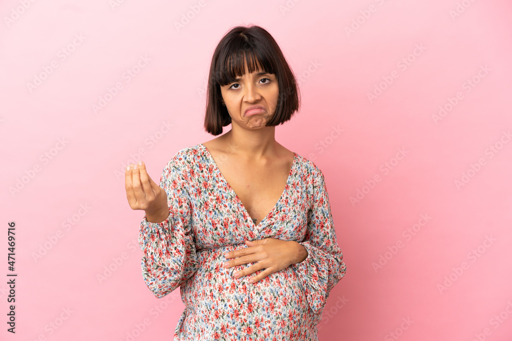 Young pregnant woman over isolated pink background making Italian gesture Young pregnant woman over isolated pink background making Italian gesture