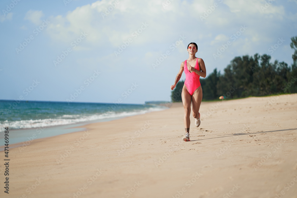 Healthy lifestyle. Jogging outdoors. Young woman exercising on sea beach.