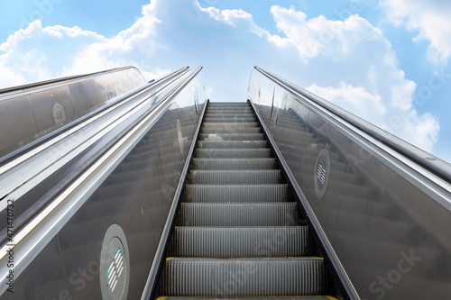 escalator with the sky in the background