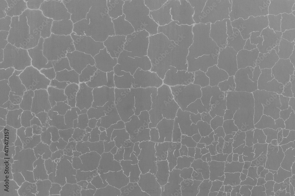 Gray textured surface for backdrop. Cracks with white highlights. Gray textured surface for backdrop. Cracks with white highlights.
