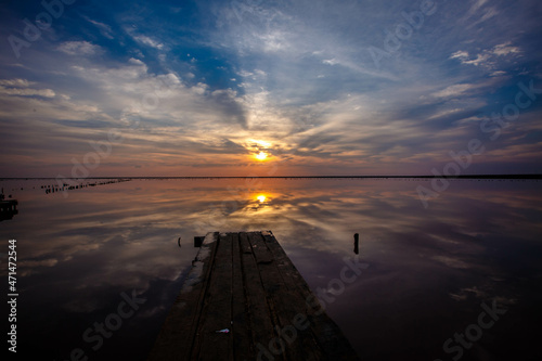 Sunset on the Pink Lake in Ukraine as seen from the pier. The water looks pink because of the special algae that grows with a high salt content.