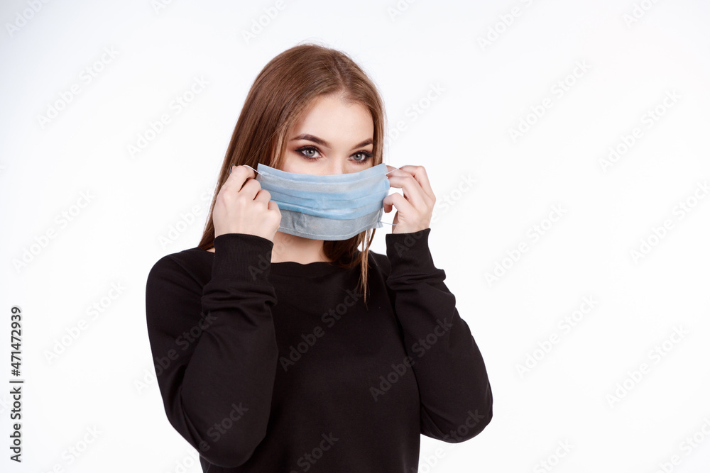 Young girl in a protective mask from the virus on a white background Young girl in a protective mask from the virus on a white background