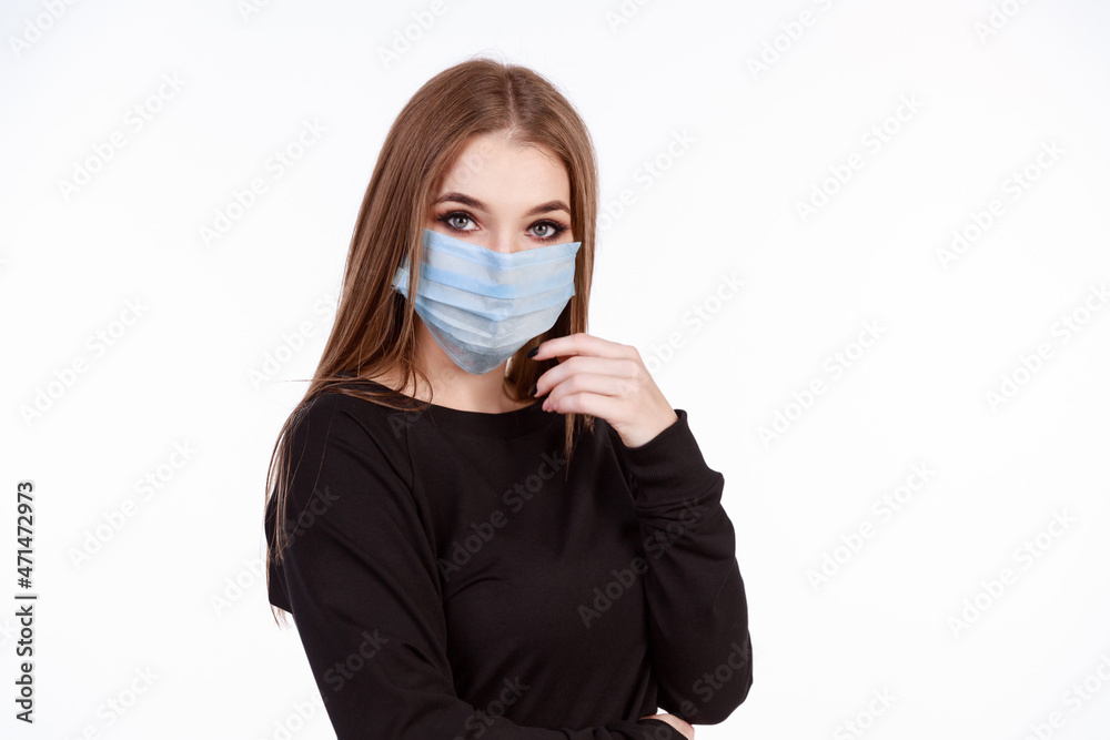 Young girl in a protective mask from the virus on a white background Young girl in a protective mask from the virus on a white background