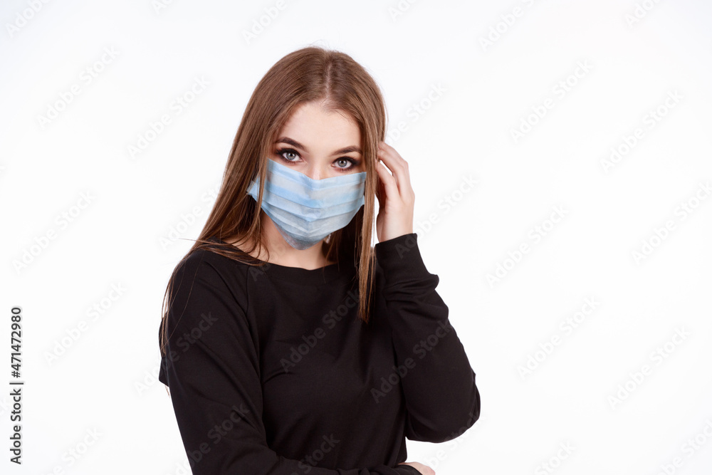 Young girl in a protective mask from the virus on a white background Young girl in a protective mask from the virus on a white background