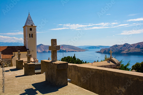 St John the Baptist Church and cemetrey, on a hill overlooking Baska town on Krk island, Primorje-Gorski Kotar County. Also called Crkva Svetog Ivana. The island in the background is Otok Prvic
