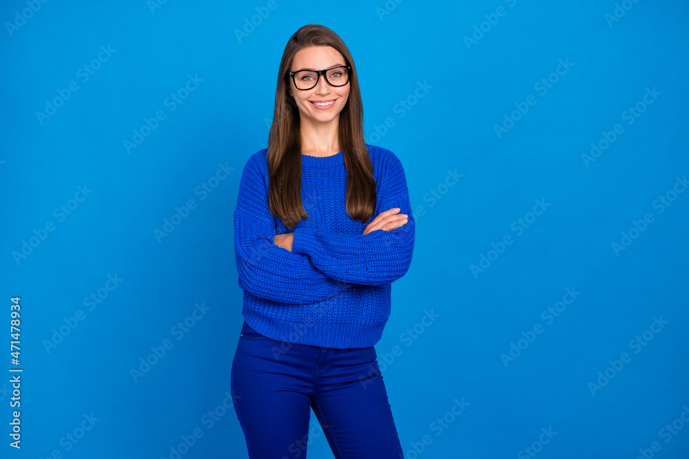 Portrait of attractive cheerful content girl executive assistant wearing jumper folded arms isolated over bright blue color background Portrait of attractive cheerful content girl executive assistant wearing jumper folded arms isolated over bright blue color background