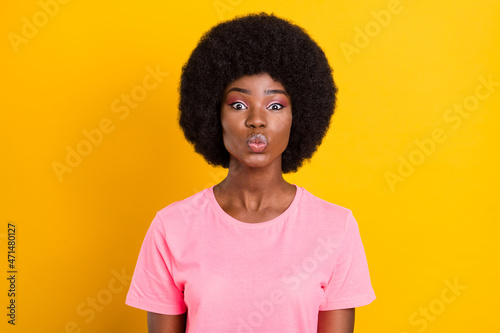 Photo of young afro girl pouted lips send air kiss flirty romantic isolated over yellow color background