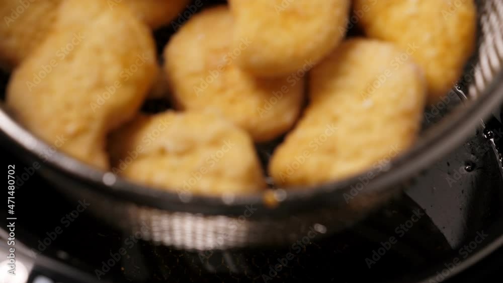 Cooking tempura chicken nuggets in deep fryer. Closeup Cooking tempura chicken nuggets in deep fryer. Closeup