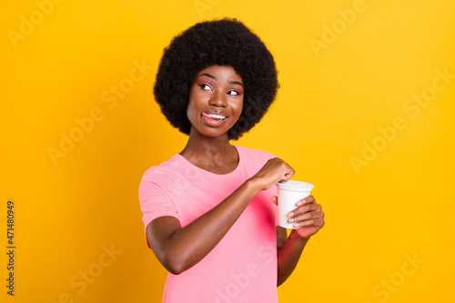 Photo of young black girl happy positive smile dream lick lips yummy eat snack jar isolated over yellow color background