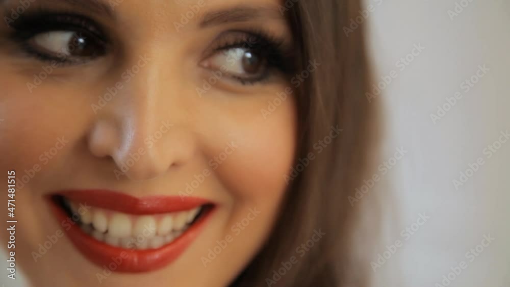 Lady in red. Woman in red. The woman in the red dress. Woman in red poses for the photographer in the studio. 