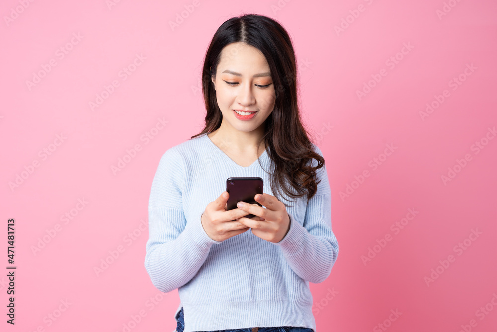 Portrait of a beautiful young Asian girl, isolated on pink background Portrait of a beautiful young Asian girl, isolated on pink background