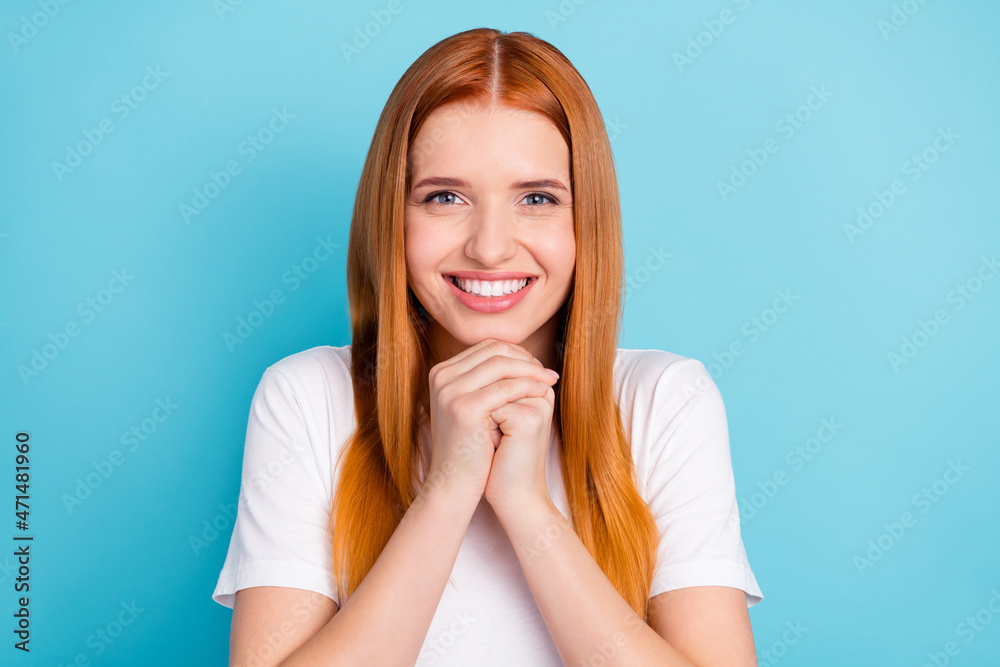 Photo of pretty positive orange hair girl folded arms under chin toothy smile isolated on blue color background Photo of pretty positive orange hair girl folded arms under chin toothy smile isolated on blue color background
