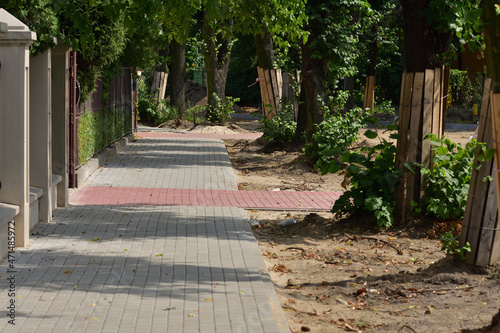 Renovation of the pavement, excavation and protection of trees from destruction in a small town.