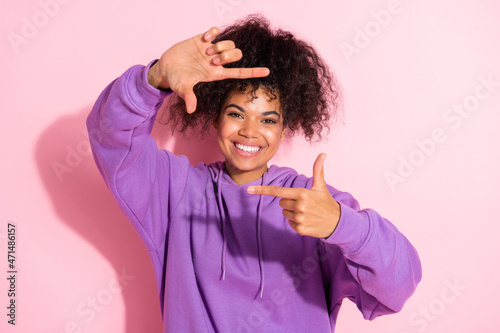 Portrait of pretty positive lady hands make cadre gesture beaming smile look camera isolated on pink color background