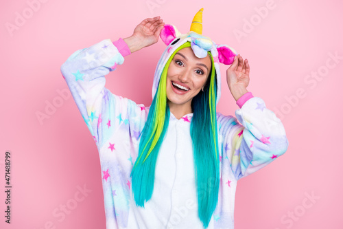 Portrait of attractive funny cheerful girl wearing kigurumi having fun isolated over pink pastel color background