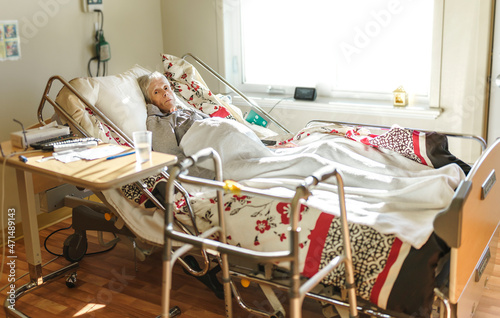 Sick, elderly senior woman in a hospital bed