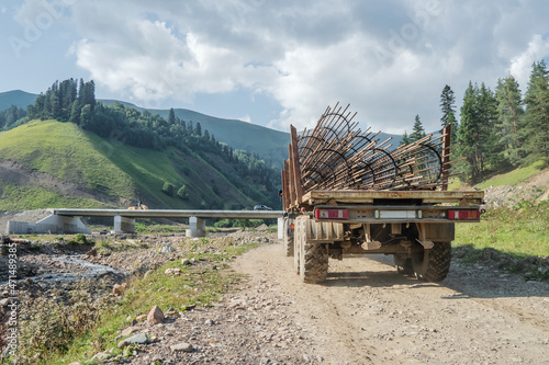 A truck transports a frame made of reinforcement for the construction of the bridge support structures.
