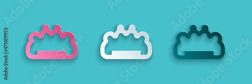 Paper cut Brass knuckles icon isolated on blue background. Paper art style. Vector